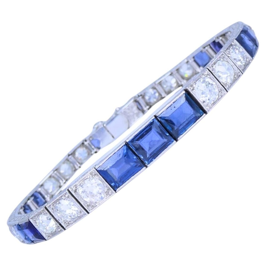 Platinum Art Deco Bracelet with Diamonds and Blue Sapphires: Platinum Art Deco Bracelet with Diamonds and Blue Sapphires An Art Deco tennis bracelet in platinum featuring alternating diamonds and blue sapphires. The design reflects the clean geometry and refine