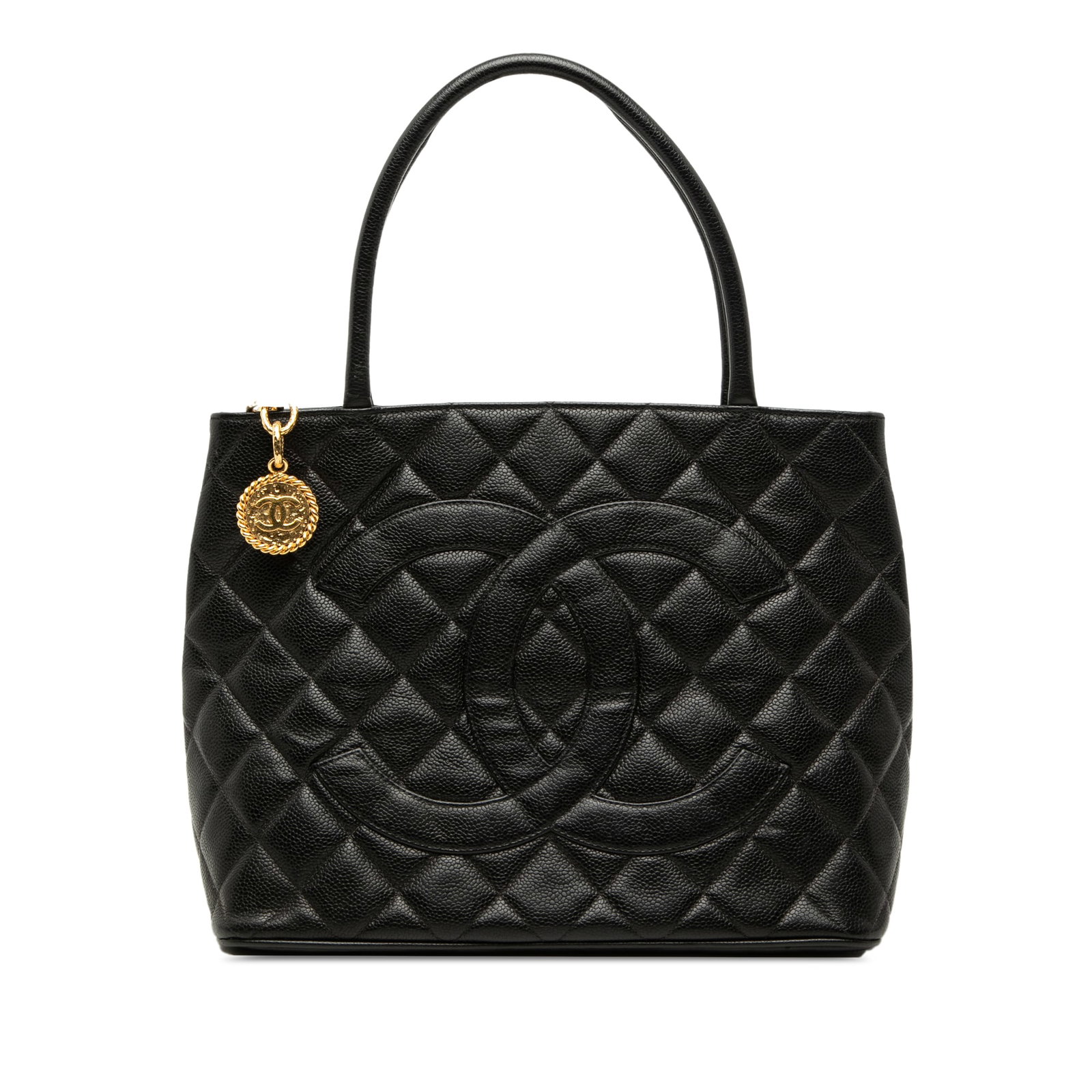 Chanel Medallion Tote in Black Caviar Leather: Chanel Medallion Tote in Black Caviar Leather Chanel Medallion tote crafted in quilted caviar leather with rolled leather handles and a top zip closure. The bag includes an exterior back slip pocket a