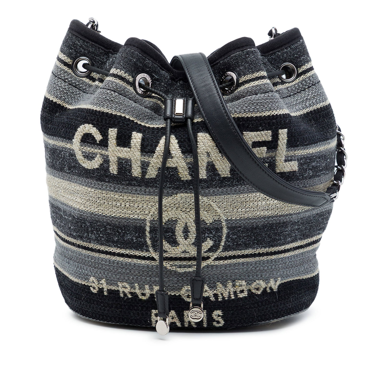 Chanel Deauville striped bucket bag in canvas wool and calf leather: Chanel Deauville striped bucket bag in canvas wool and calf leather Chanel Deauville drawstring bucket bag crafted with a canvas, wool, and calf leather body. It features a leather woven chain strap w