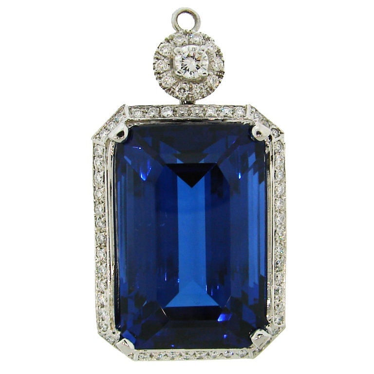 18K White Gold Pendant with 61.41 Carat Tanzanite and Diamonds: 18K White Gold Pendant with 61.41 Carat Tanzanite and Diamonds Contemporary pendant featuring an extra fine gem-quality tanzanite of exceptional size and color, framed in 18 karat white gold with diam