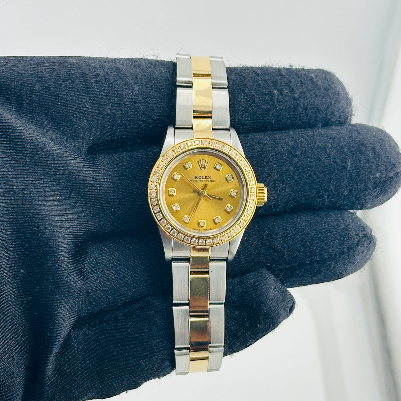 Ladies Rolex Oyster Perpetual Ref 67193 Oyster Bracelet Aftermarket Dial: Ladies Rolex Oyster Perpetual Ref 67193 Oyster Bracelet Aftermarket Dial Ladies Rolex Oyster Perpetual wristwatch featuring an Aftermarket champagne dial with yellow diamond markers, a pave plated dia