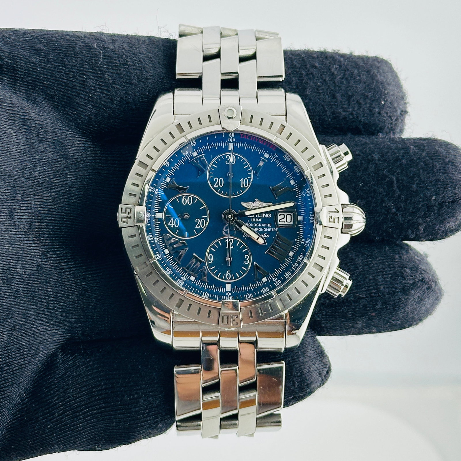 Breitling A13356 Chronomat Evolution mens watch blue Roman dial with papers: Breitling A13356 Chronomat Evolution mens watch blue Roman dial with papers Breitling Chronomat Evolution men's wristwatch with a blue Roman numeral dial, rotating steel bezel, and stainless steel bra