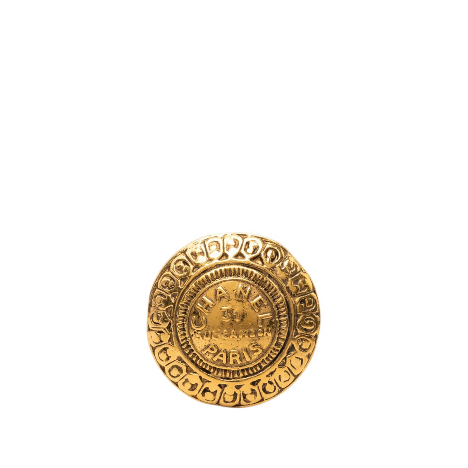 Chanel 31 Rue Cambon round gold plated brooch: Chanel 31 Rue Cambon round gold plated brooch Round Chanel brooch in gold-plated metal featuring the 31 Rue Cambon motif and a back pin closure. Made in France, this costume jewelry piece shows visibl