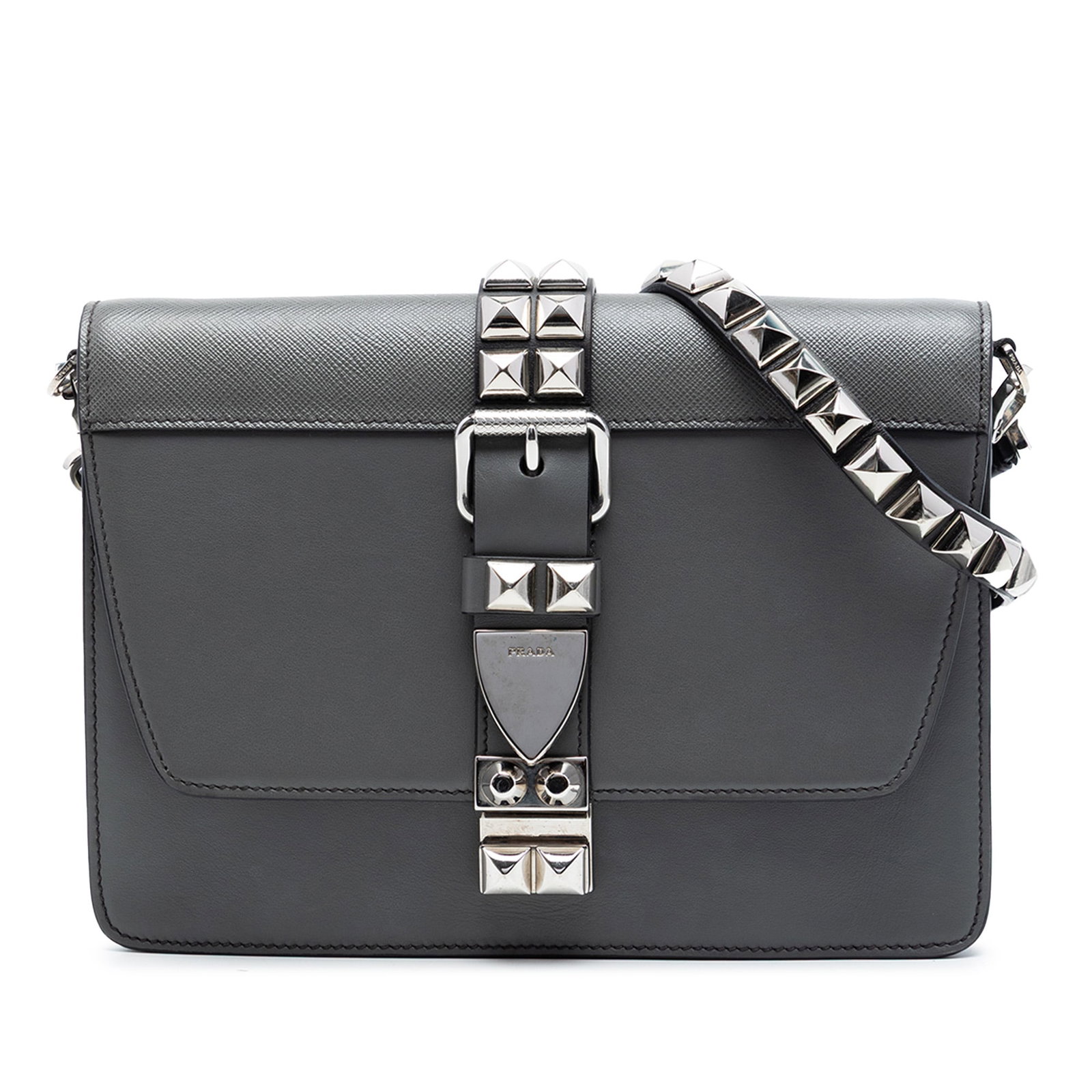 Prada Elektra Leather Crossbody Bag Gray City Calf Saffiano: Prada Elektra Leather Crossbody Bag Gray City Calf Saffiano Prada Elektra crossbody bag in gray leather, featuring stud details, an adjustable studded flat leather strap, a top flap with push lock clo