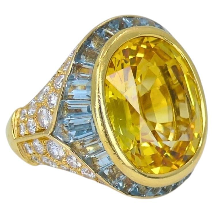 Vintage Bvlgari 18k Yellow Gold Ring with Yellow Sapphire Aquamarine Diamonds: Vintage Bvlgari 18k Yellow Gold Ring with Yellow Sapphire Aquamarine Diamonds Vintage Bulgari ring in 18k yellow gold, featuring a 13.20-carat oval faceted yellow sapphire at the center, surrounded by