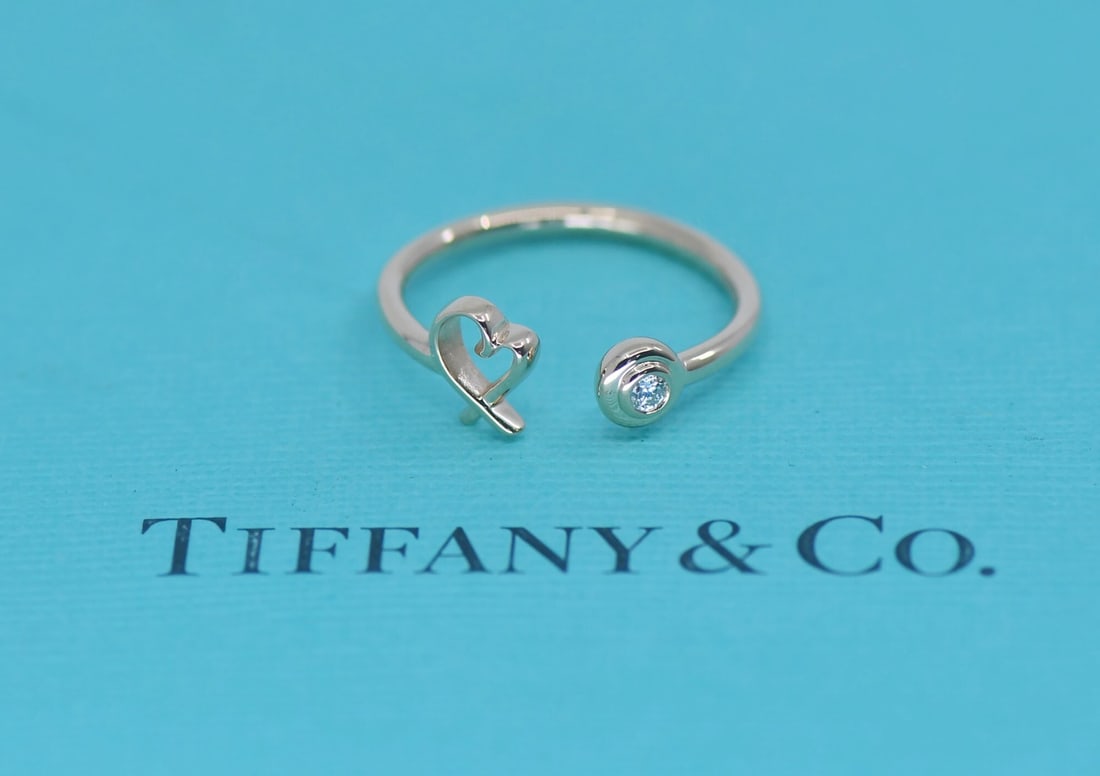 Tiffany & Co Paloma Picasso 18K Rose Gold Diamond Band Ring Size 6: Tiffany & Co Paloma Picasso 18K Rose Gold Diamond Band Ring Size 6 Tiffany & Co. Paloma Picasso diamond ring crafted in 18k rose gold. This signed band-style ring features natural round diamonds and c