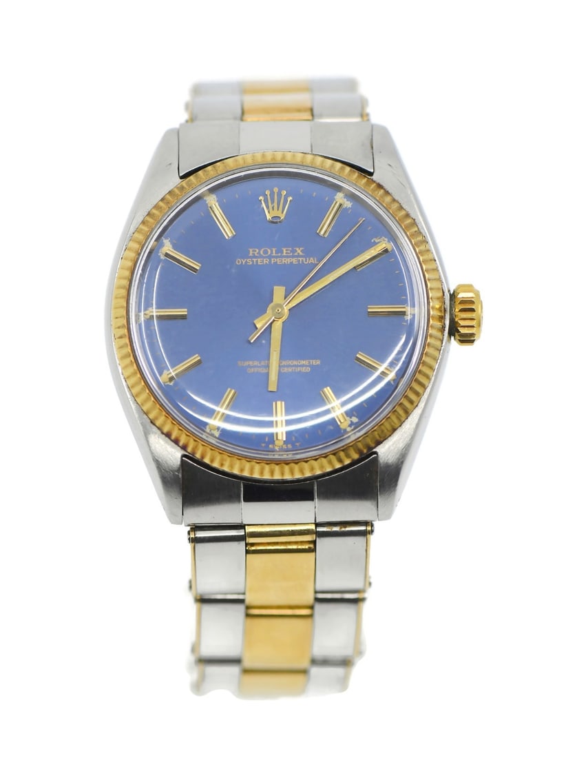Rolex Oyster Perpetual Ref 1005 Blue Dial 34mm 18K Stainless Steel Automatic Watch: Rolex Oyster Perpetual Ref 1005 Blue Dial 34mm 18K Stainless Steel Automatic Watch This Rolex Oyster Perpetual 1005 is a classic wristwatch featuring a 34 mm stainless steel case with 18K gold accents