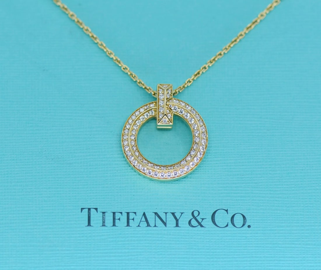18K Yellow Gold Tiffany & Co T1 Circle Diamond Pendant Necklace: 18K Yellow Gold Tiffany & Co T1 Circle Diamond Pendant Necklace Tiffany & Co. T1 Circle diamond necklace in 18k yellow gold with a round pendant charm design. This pre-owned necklace features natural,