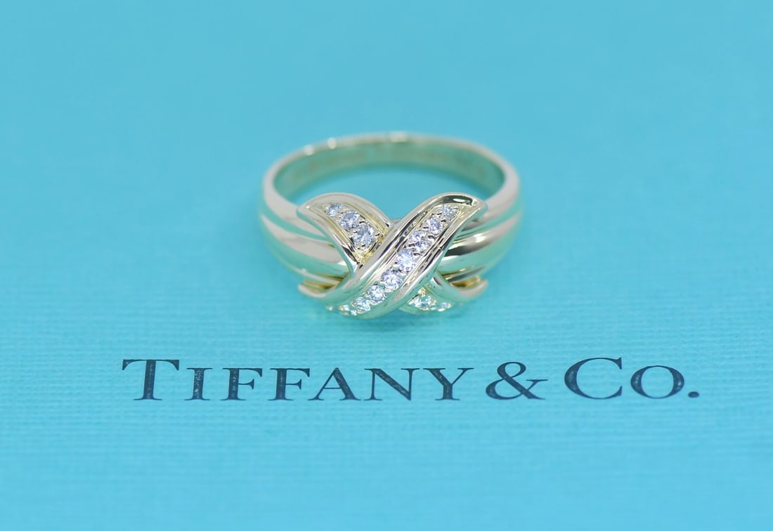 Tiffany & Co X Diamond Ring 18K Yellow Gold Size 6: Tiffany & Co X Diamond Ring 18K Yellow Gold Size 6 Tiffany & Co. X ring crafted in 18k yellow gold and set with a diamond. This pre-owned ring is made in Italy and includes its box. Specifications Bra