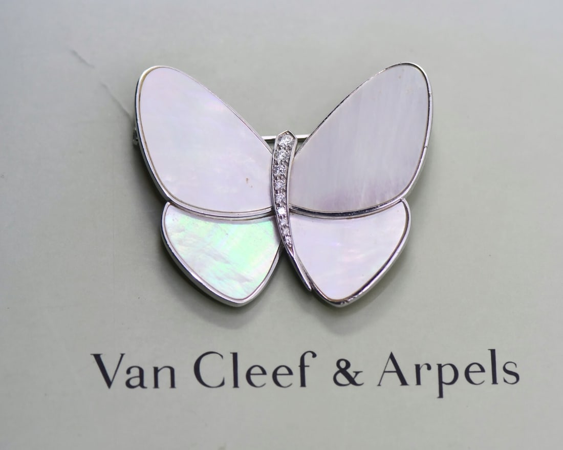 Van Cleef & Arpels Diamond Butterfly Brooch in 18K White Gold: Van Cleef & Arpels Diamond Butterfly Brooch in 18K White Gold This exquisite Van Cleef & Arpels Butterfly Brooch features a stunning design crafted from 18K white gold, accentuated with brilliant diam