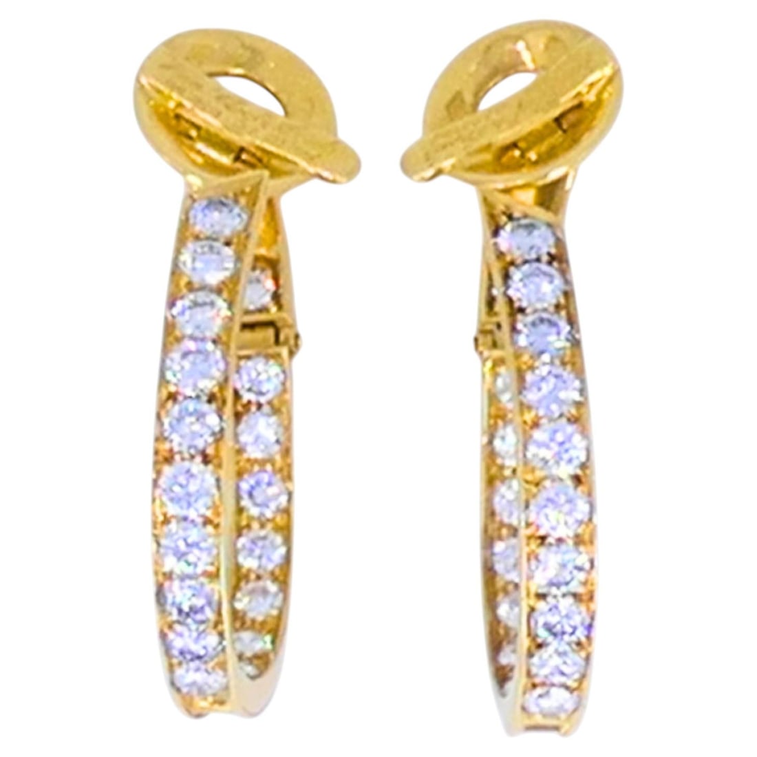 Van Cleef and Arpels diamond oval hoop earrings in 18k yellow gold: Van Cleef and Arpels diamond oval hoop earrings in 18k yellow gold An elegant pair of Van Cleef & Arpels diamond hoop earrings crafted in 18k yellow gold. The oval hoop design is set along the front w