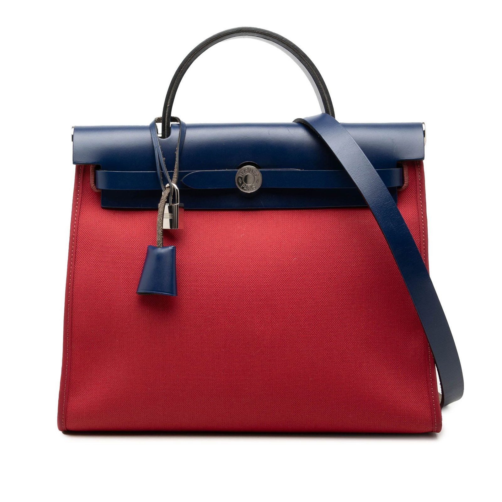 Hermes Toile Herbag Zip 31 Shoulder Bag Red: Hermes Toile Herbag Zip 31 Shoulder Bag Red The Hermes Toile Herbag Zip 31 is a structured bag with a canvas body and leather trim. It features a flat leather top handle, a flat leather shoulder strap