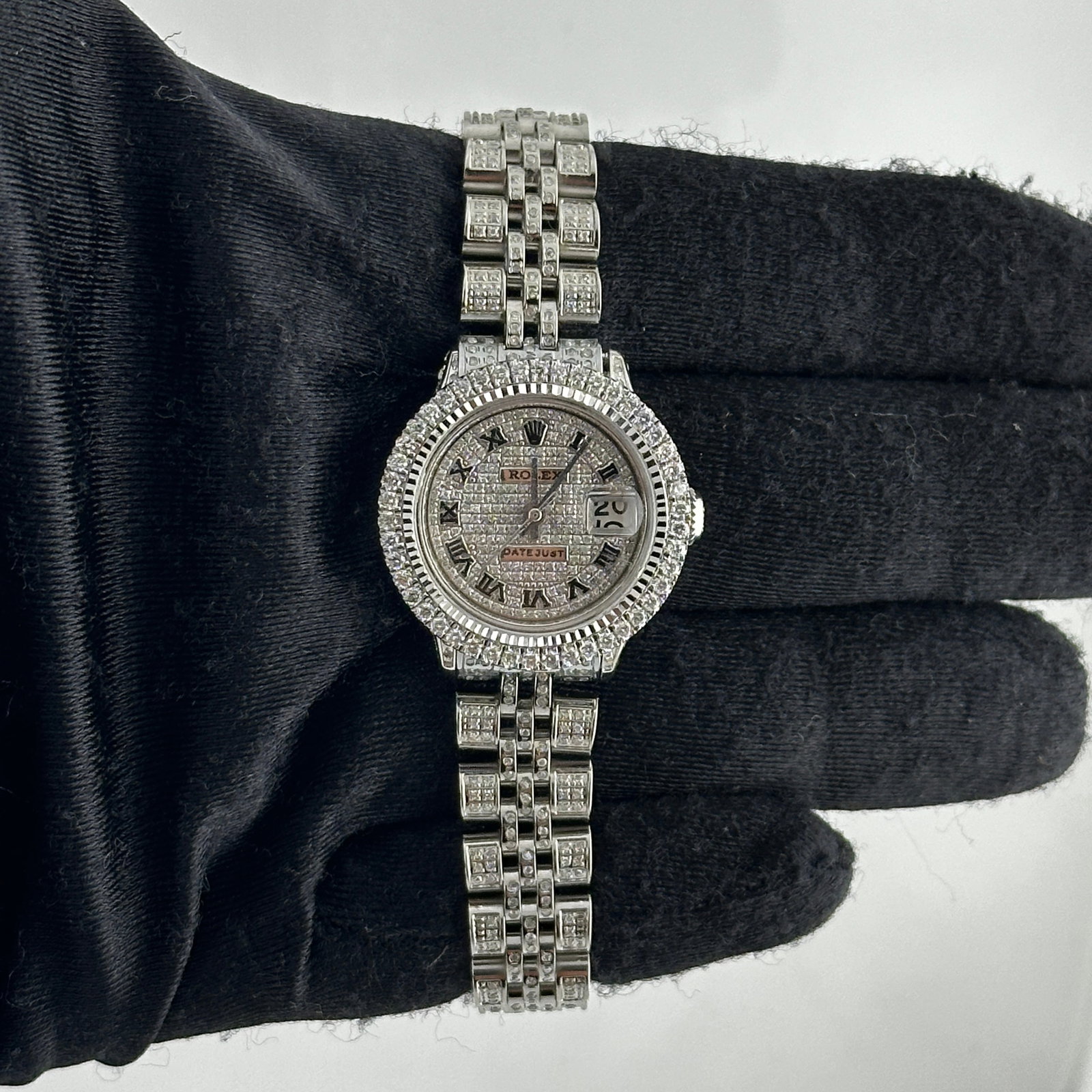 Rolex Datejust 6517 Ladies Watch aftermarket iced Roman dial Jubilee bracelet: Rolex Datejust 6517 Ladies Watch aftermarket iced Roman dial Jubilee bracelet This ladies' Rolex Datejust features an iced-out Roman dial, a prong diamond bezel, and a Jubilee bracelet adorned with di