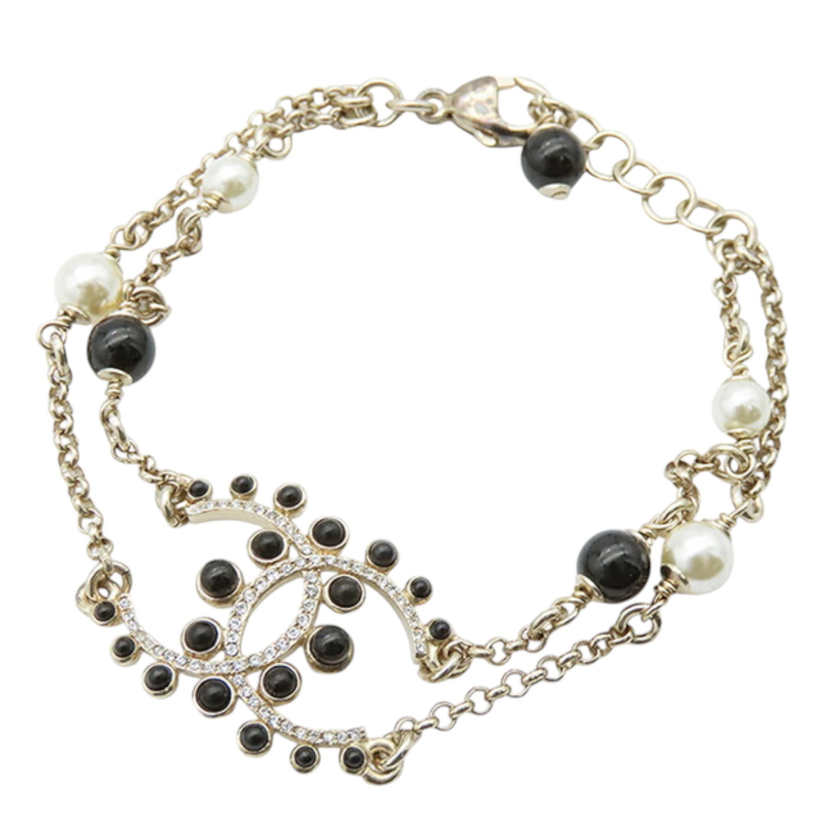 Chanel Gold Plated CC Bracelet with Faux Pearls and Rhinestones: Chanel Gold Plated CC Bracelet with Faux Pearls and Rhinestones Elevate your accessory collection with this stunning Chanel bracelet, featuring a luxurious gold-tone metal body adorned with faux pearl