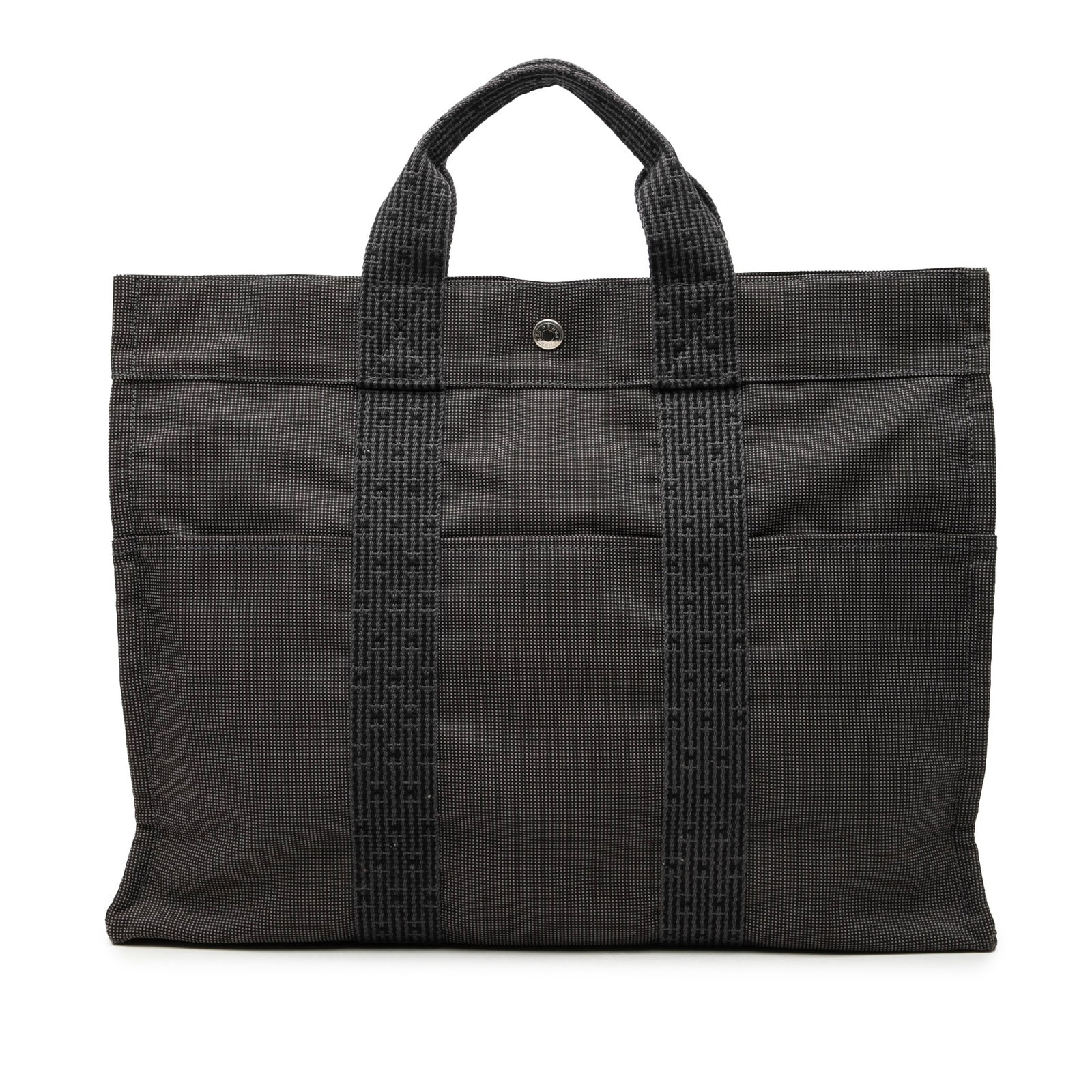 Hermes Herline MM gray canvas tote bag: Hermes Herline MM gray canvas tote bag Hermes Herline MM tote bag in gray canvas with flat handles and a top zip closure. The design includes exterior slip pockets at the front and back, along with an