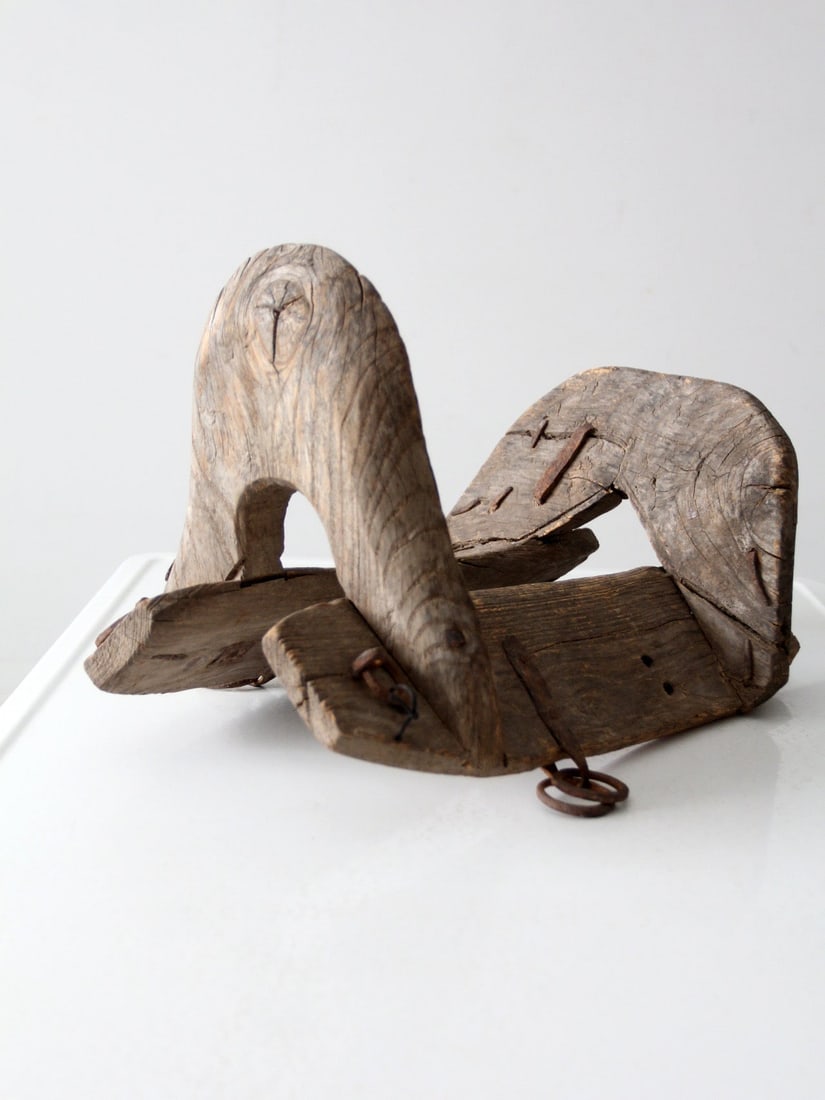Antique Hand-Carved Wooden Saddle Yoke with Iron Rings: Antique Hand-Carved Wooden Saddle Yoke with Iron Rings This antique hand-carved wooden saddle yoke showcases exquisite craftsmanship and a rich history. Originally used for draft animals, it features 