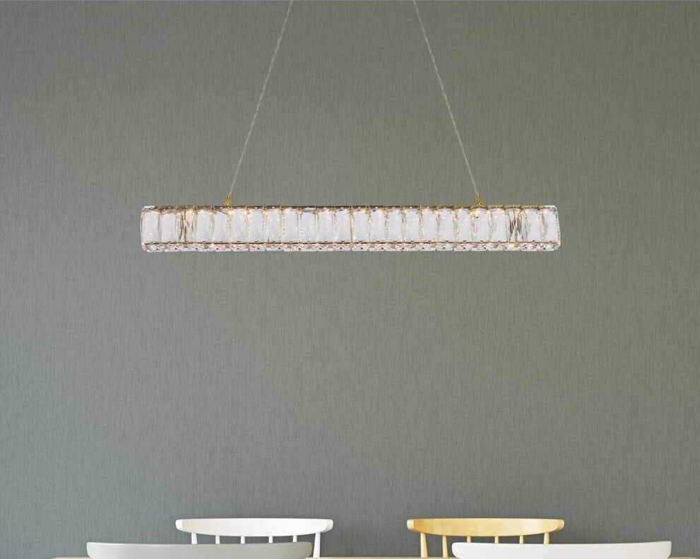 Monroe LED Goldish Crystal Pendant 31 in Adjustable Height: Monroe LED Goldish Crystal Pendant 31 in Adjustable Height This modern crystal chandelier features a gold finish and is designed for versatile use in spaces such as foyers, kitchens, dining rooms, bed