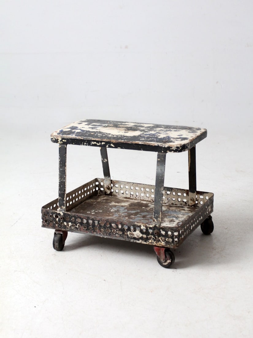 Vintage Mid-Century Industrial Rolling Cart Stool with Metal Frame: Vintage Mid-Century Industrial Rolling Cart Stool with Metal Frame This mid-century industrial rolling cart stool is designed with a perforated metal frame and a wood top, showcasing a unique blend of