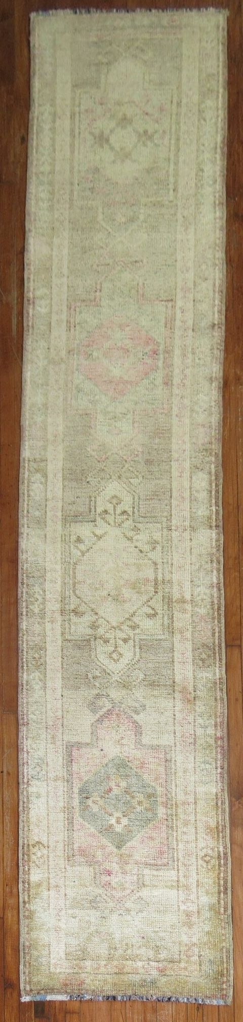 2' 7" x 13' Turkish Kars rug runner mid-20th century: 2' 7" x 13' Turkish Kars rug runner mid-20th century A pale Turkish Kars runner from the mid 20th century, featuring a neutral color palette and traditional geometric patterning. This pre-owned runner