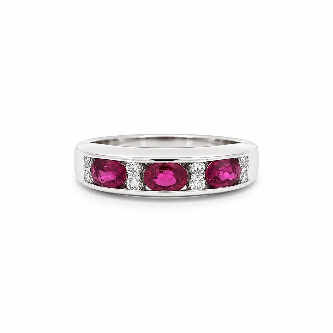 Platinum Band Ring with 3 Oval Rubies and 8 Diamonds 1.06ctw: Platinum Band Ring with 3 Oval Rubies and 8 Diamonds 1.06ctw Pre-owned platinum band ring featuring three natural oval rubies set east-west in a channel setting, accented by eight round brilliant diam