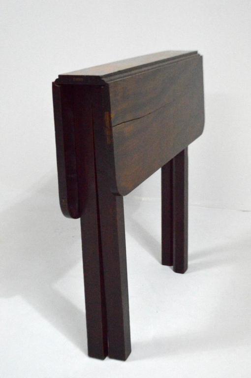George III Mahogany Gate-Leg Folding Table, Circa 1840: Of diminutive size, with a shaped rectangular top supported by four rectangular legs. When folded, this table is approximately 5 in. wide.