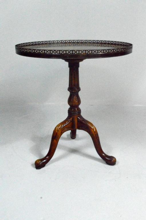 George III Style Tea Table: With a brass galleried top over a round surface inlaid with fruitwood bellflowers and a central fruitwood star, the turned urn form column supported by three carved cabriole legs ending in paw feet.