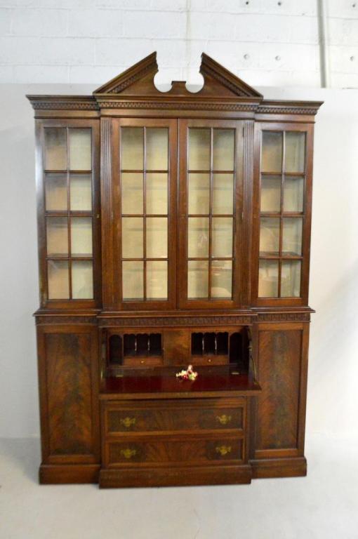 George III Style Mahogany Butlers Breakfront: In two parts, the upper part with a broken arch pediment over two glazed doors flanked by one glazed door to each side; the lower section with a Hellenic Key moulding at the top with four drawers flan