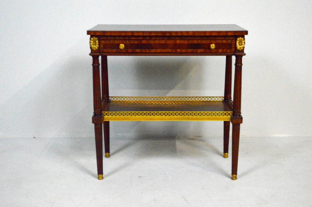Regence Side Mahogany Side Table by Maitland-Smith: With an inlaid rectangular top over a single banded drawer and flanked by pull out candle slides, the whole raised on three turned and fluted legs supported by a brass galleried inlaid mahogany shelf.