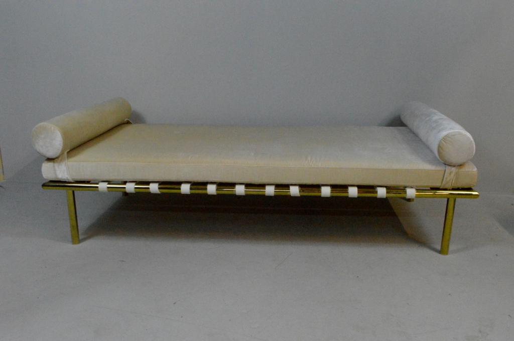 Contemporary Brass Day Bed with White Mattress: A contemporary daybed with brass base, vinyl straps and a velveteen mattress and pillows.