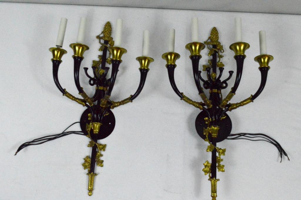 Pair of Regency Style Four Light Sconces: Wired. Each with four tole and gilt arms extending from a central tole and gilt column.