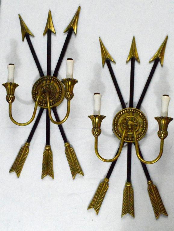 Pair of Two Light Crossed-Arrow Sconces: Each consisting of three black and gold crossed arrows with two arms rising from the bound point.