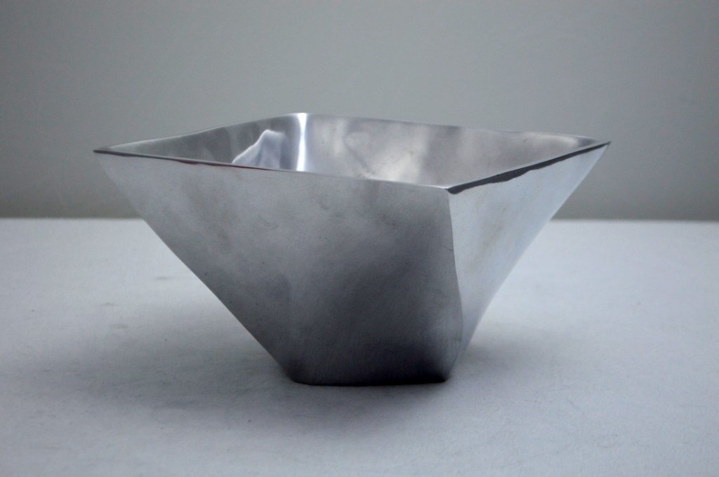 Mid-Century Biomorphic Aluminum Bowl: Unmarked, square rim with twist form tapering sides in the manner of Nambe/Fred Bould or Bruce Fox. Property of Walter Wagner.
