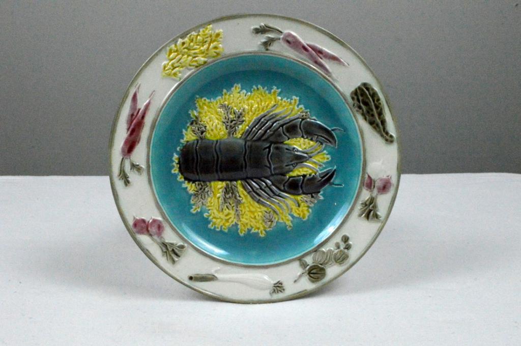 Wedgwood Majolica Argent Lobster Plate: With A blue ground center with a lobster, the white ground rim with carrots, mushrooms, radishes, and green onions, marked on base.