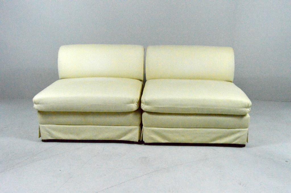 Pair of Modular Settees: Each with a scrolling crest rail over an upholster seat and dust ruffles