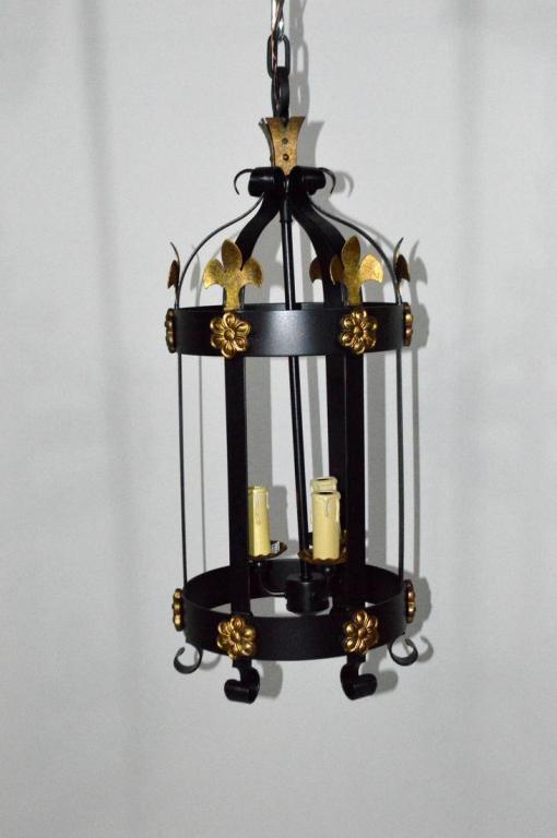Pair of Wrought Iron and Parcel Gilt Lanterns: Each three light with fleur di lis decoration. One of pair still in original packaging.