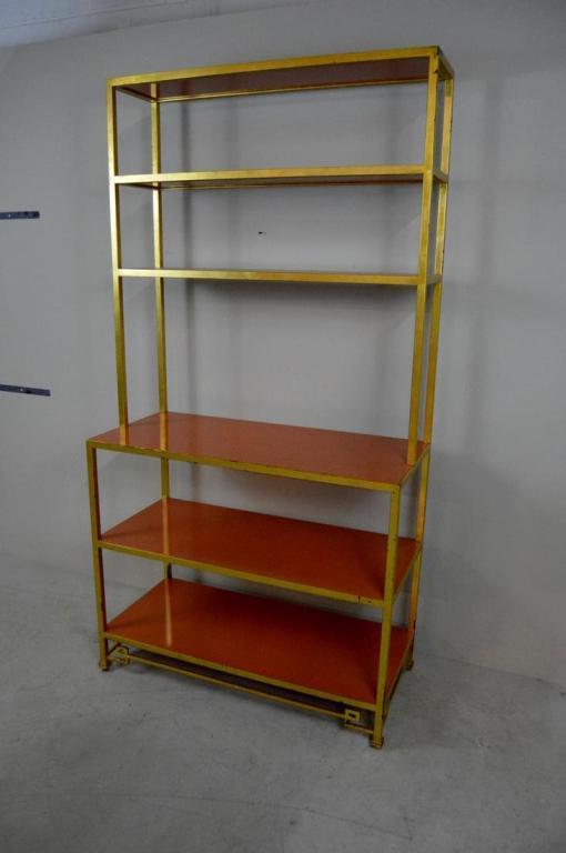 Parish-Hadley Orange Lacquer Metal Etagere: From the partnership of Sister Parish and Albert Hadley, with three orange lacquer shelves supported by gilted cast iron over 3 large orange lacquer shelves, the whole raised on 4 peg feet. 85 x 44 x 