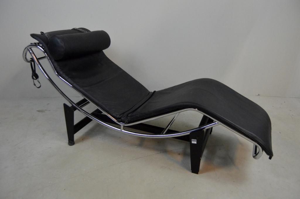 Le Corbusier Style Chaise Lounge: LC4 style chaise lounge, In two parts, with rubber banding between rails and covered in attachable black leather cover with pillow. 27 x 22 x 63 in.