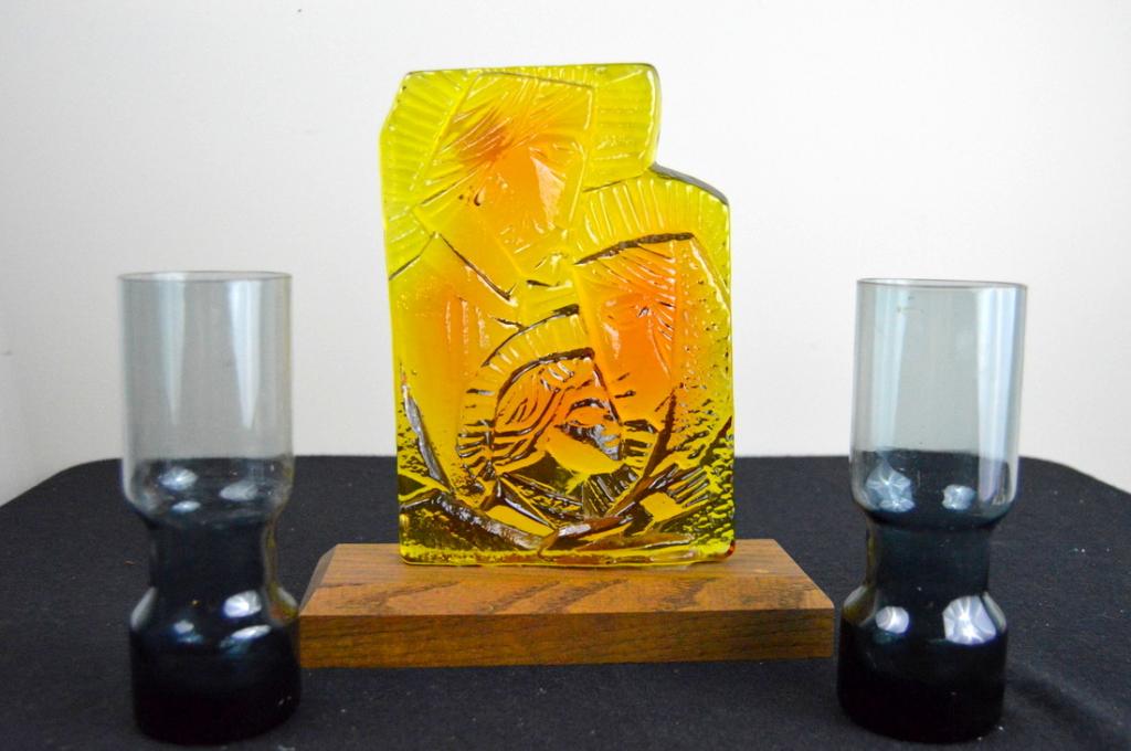 Blenko Glass Plaque and Two Votives: A group of Blenko glass, including a gold Christmas plaque featuring Joseph, Mary and Jesus, and two glue tall votives. Plaque is 11" tall, Votives are 7.5" in height.