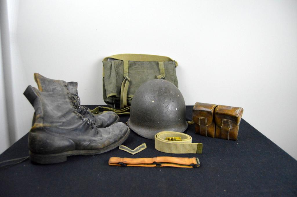 WWII Helmet, Boots and Gunny Sack: Helmet without liner, well pitted with rust. Also included are a magazine pouch and gunny sack.