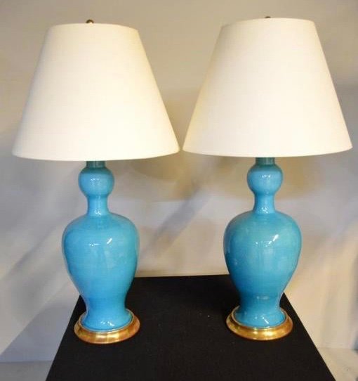 Pair of Christopher Spitzmiller Turquoise Lamps: Each with two lights over a shaped neck and wide shoulder tapering and expanding to a wide base, raised on a parcel gilt metal base. Signed on bottom.