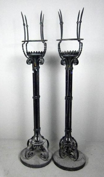 Pair of Wrought Iron Braziers: NOTE : Blistering to paint throughout , legs on 1 bent both affixed to circular concrete base . 78 x 18 x 18 in.