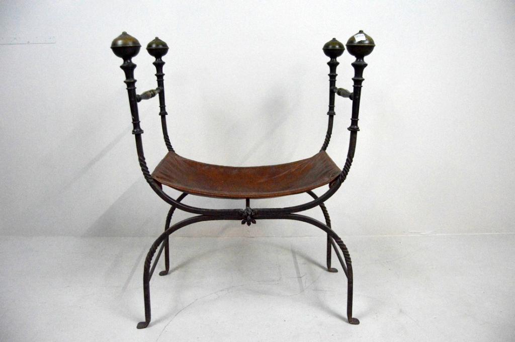 Metal and Leather Savonarola Chair: Bent iron frame with four knob posts over a leather seat. Frame folds up. Sometimes called a Curule Chair or Dante Chair. 35 x 28 x 16.5 in.