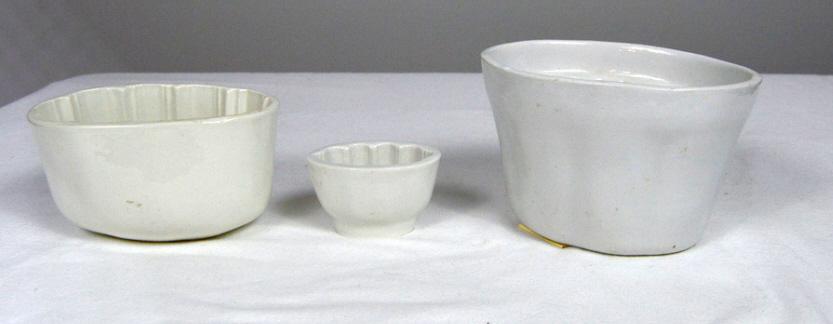 Three Ironstone Molds: Largest: 4.5 x 7 x 5.5 in. Middle: 3.75 x 6.5 x 4 in. Smaller: 2.25 x 3.5 x 2.25 in.