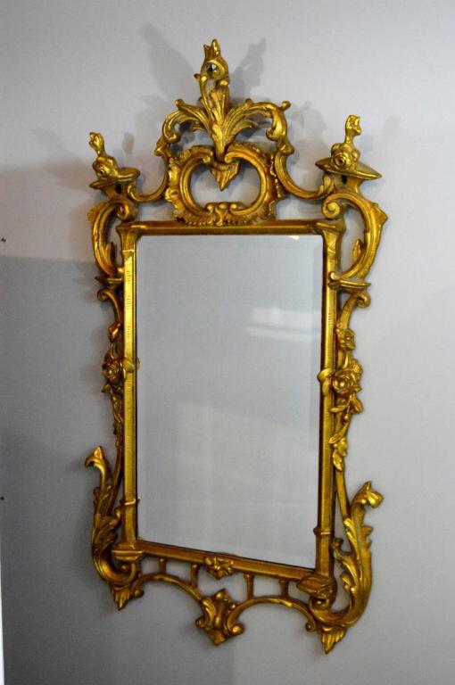 George III Style Giltwood Mirror: With acanthus finial and rocaille posts surrounding a square , beveled glass 50 x 26 x 3 in.