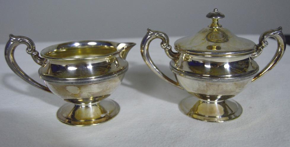 Creamer and Sugar Bowl: 1 silver plate creamer. Marked and numbered. 3 in.x 5 in. 1 Sugar Bowl Apollo made by Bernard Rice and Sons, Inc.