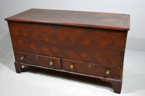 American Painted Blanket Chest: The moulded rectangular top opening to reveal a large compartment with later storage box over two locked drawers the whole raised on four ogee bracket feet. Painted. Poplar primary and secondary