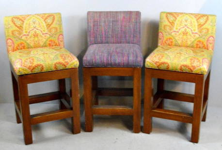 Three Upholstered Bar Stools: Each swiveling seat with upholstered backs and seats, raised on four square legs supported by stretchers. Each: 40 x 20 x 20 in.