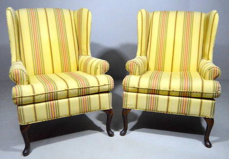 Pair of Queen Anne Style Wingback Armchairs: Each upholstered in yellow and striped with pronounced wings and arms the whole raised on cabriole legs ending in pad feet. 38 x 26 x 31 in.