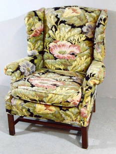 George III Style Wingback Armchair: Covered in floral fabric, with pronounced wings and scrolling arms flanking a single pad seat, the whole raised on four square legs supported by an H-stretcher. 40 x 34 x 34 in.