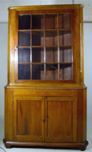 American Poplar Corner Cabinet, C. 1840: Of usual form with chamfered edges the fenestrated door opening to reveal three shelves , the bottom with two doors opening to reveal a single shelf, the whole raised on bracket feet. 86 x 51 x 22